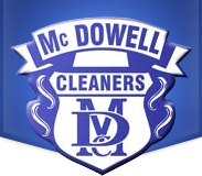 McDowell Cleaners logo featuring a blue and white shield with initials "MC" and "D" and the word "CLEANERS" across the center.